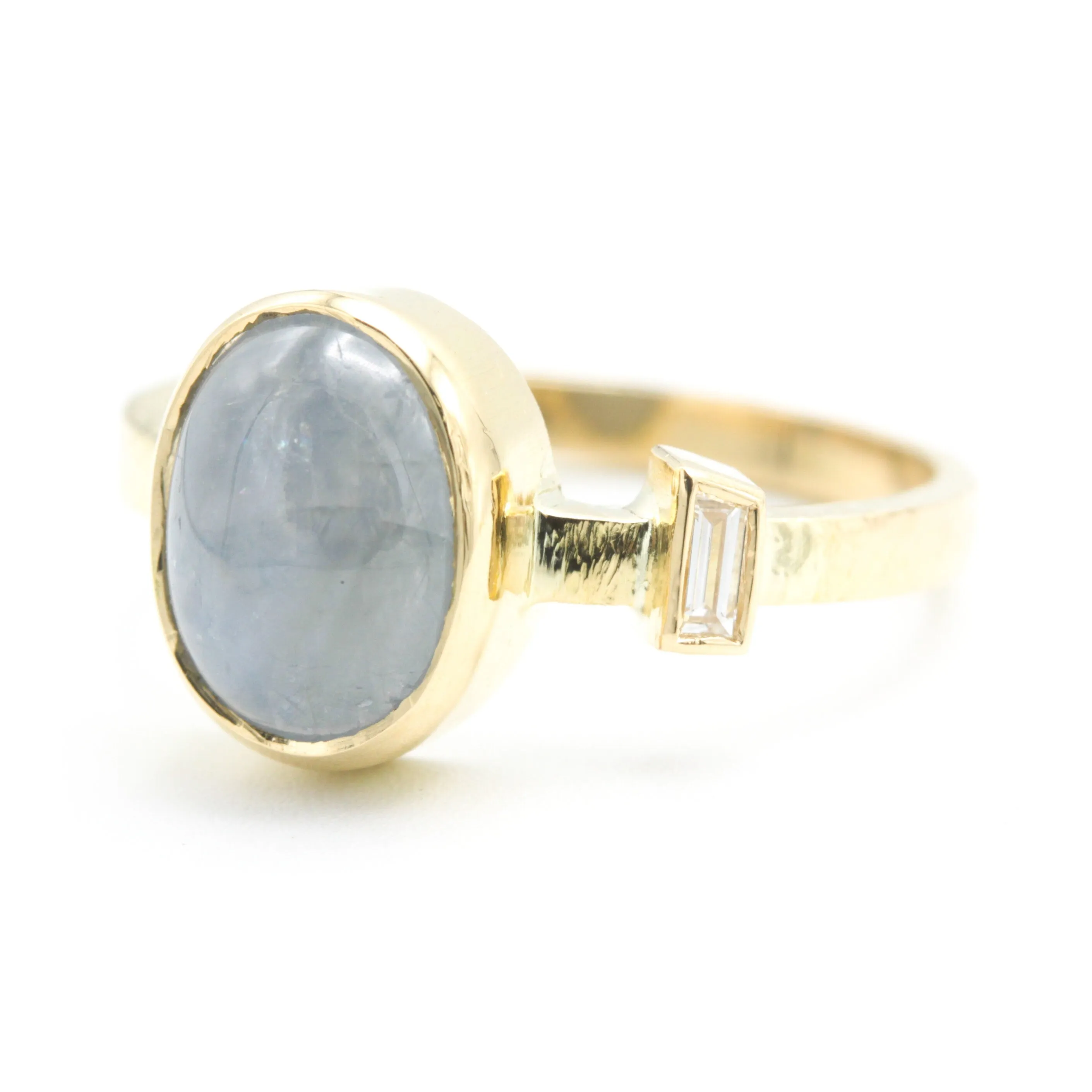 Oval blue star sapphire ring and diamond secondary with 18k gold texture band