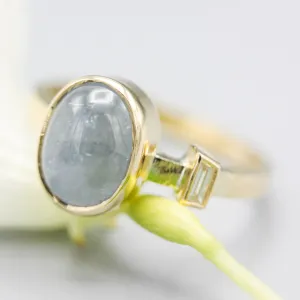 Oval blue star sapphire ring and diamond secondary with 18k gold texture band